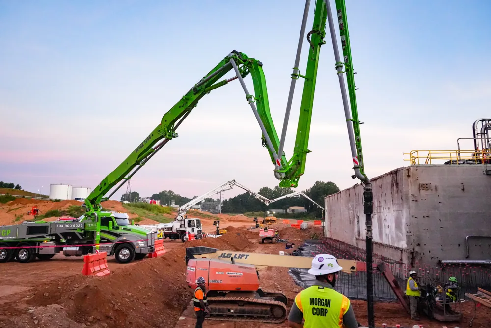 Green BFCP boom extended over a concrete jobsite
